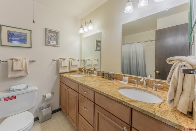 bathroom with toilet and vanity