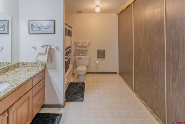 bathroom featuring curtained shower, toilet, and vanity