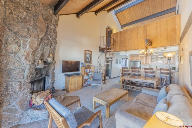 living room with a fireplace, a notable chandelier, beam ceiling, wood ceiling, and high vaulted ceiling