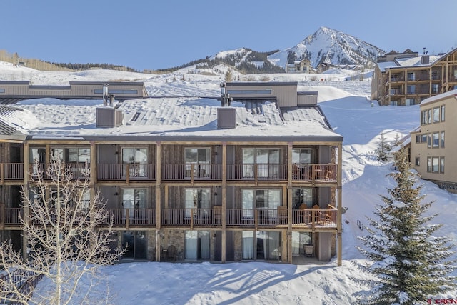 snow covered property featuring a mountain view