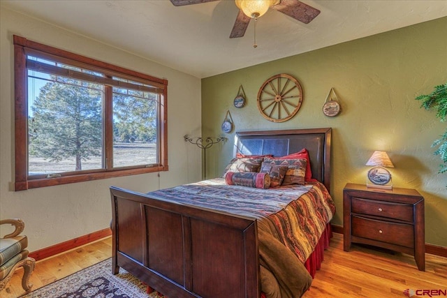 bedroom with ceiling fan and light hardwood / wood-style flooring