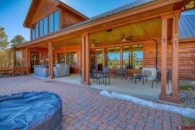 view of patio featuring ceiling fan, an outdoor living space, and grilling area