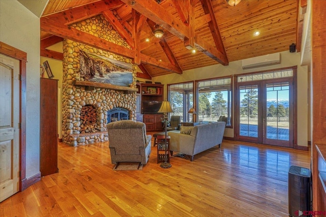 unfurnished living room with high vaulted ceiling, beam ceiling, a wall mounted AC, and a fireplace