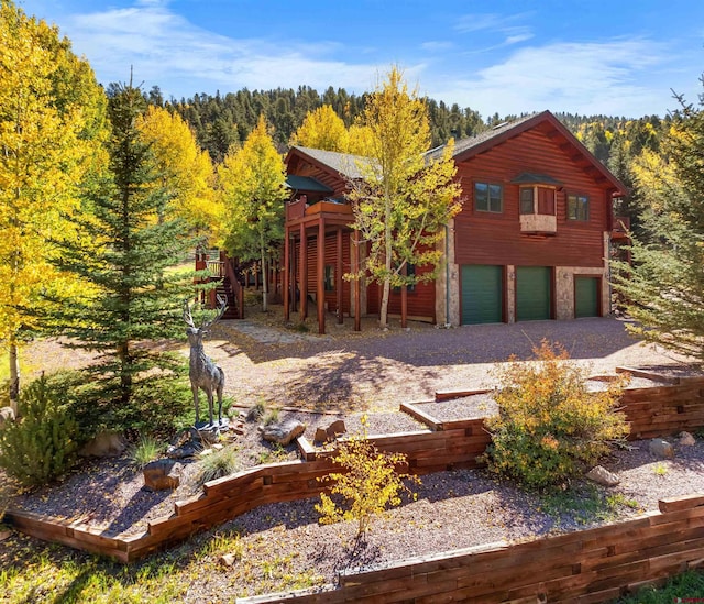 log-style house featuring a garage