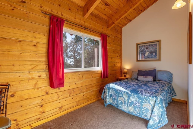 carpeted bedroom featuring lofted ceiling with beams, wood ceiling, and wooden walls