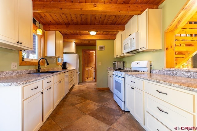 kitchen featuring white cabinets, decorative light fixtures, white appliances, and beam ceiling