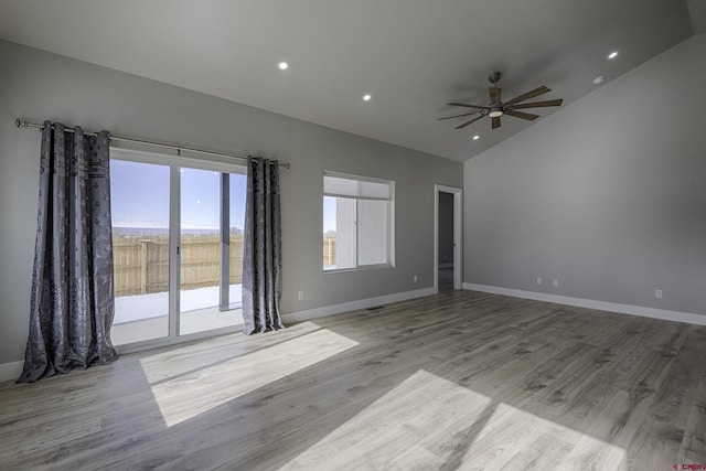 empty room featuring high vaulted ceiling, recessed lighting, a ceiling fan, baseboards, and light wood finished floors