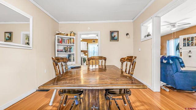 dining area with hardwood / wood-style flooring, crown molding, and ceiling fan