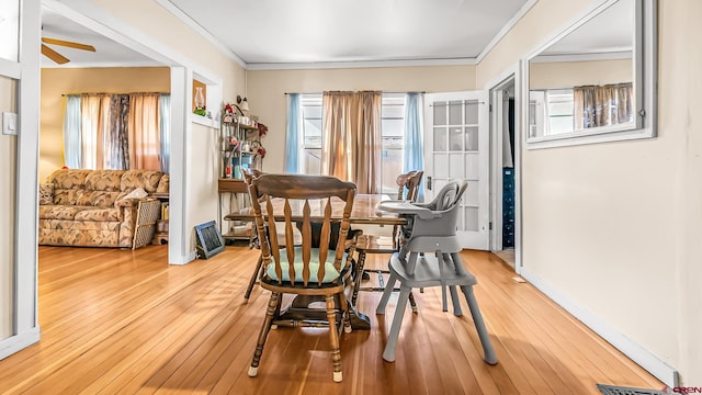 dining space with ornamental molding and hardwood / wood-style flooring