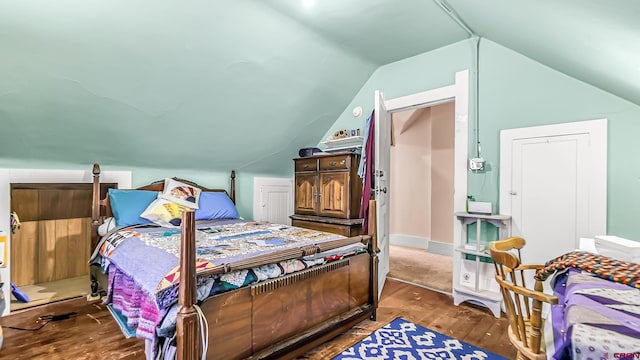 bedroom featuring hardwood / wood-style floors and lofted ceiling