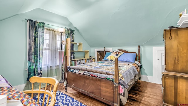 bedroom featuring vaulted ceiling and hardwood / wood-style floors