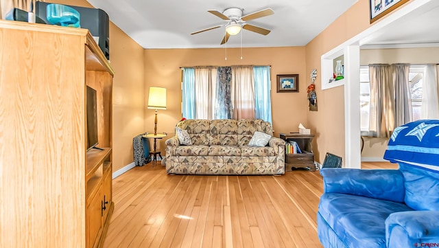 living room featuring ceiling fan and hardwood / wood-style floors