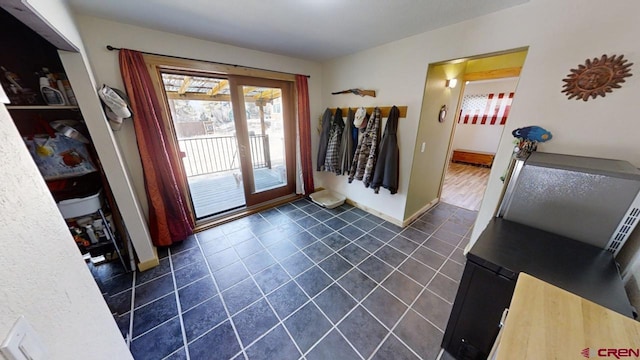 entryway featuring dark tile patterned flooring