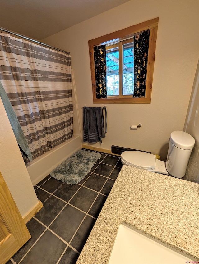 bathroom with tile patterned floors, a shower with curtain, and toilet