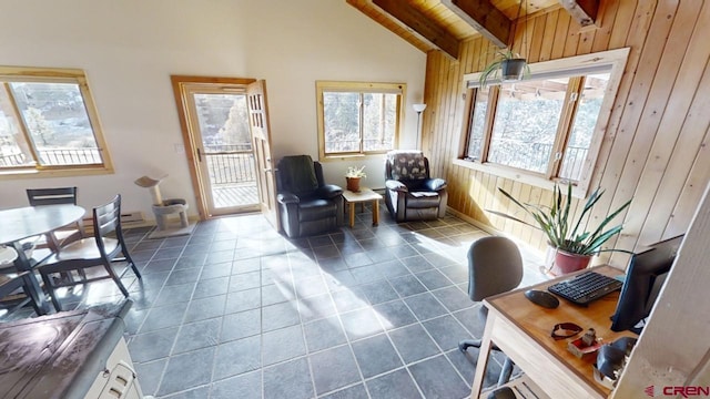 sitting room with dark tile patterned floors, vaulted ceiling with beams, and wooden walls