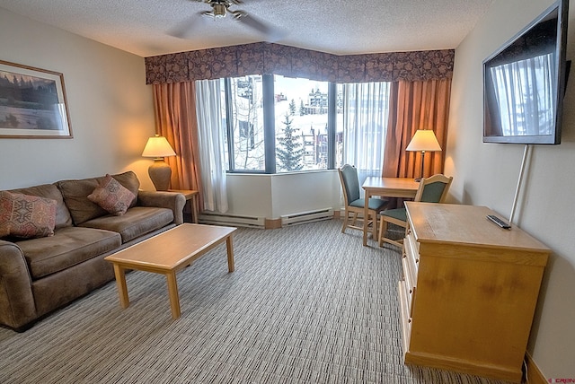 sitting room with carpet floors, a baseboard radiator, a textured ceiling, and ceiling fan