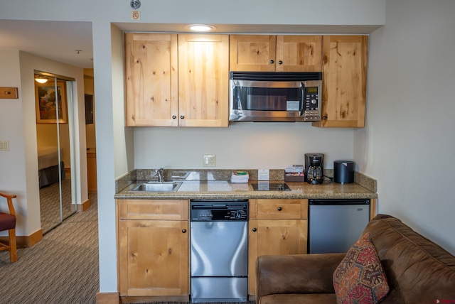 kitchen featuring carpet, sink, light brown cabinets, and stainless steel appliances