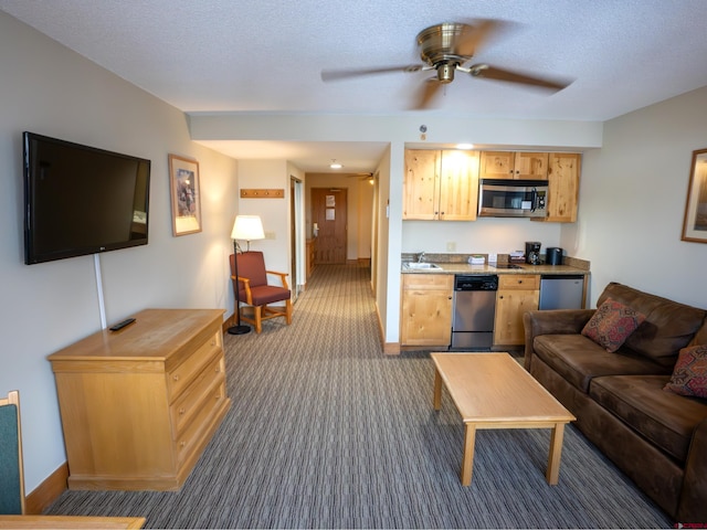 carpeted living room with ceiling fan, sink, and a textured ceiling