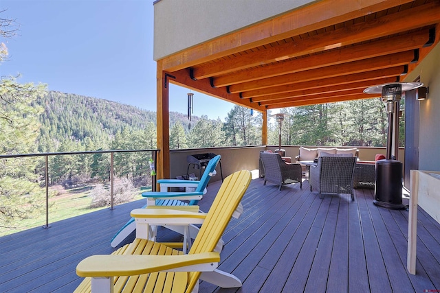 deck with an outdoor hangout area and a mountain view