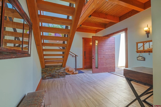 interior space featuring light wood-type flooring, beam ceiling, wood ceiling, and a healthy amount of sunlight