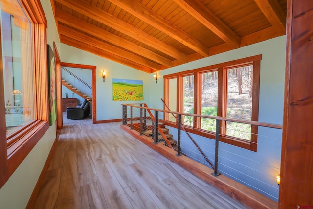 hallway featuring wooden ceiling, light wood-type flooring, and vaulted ceiling with beams