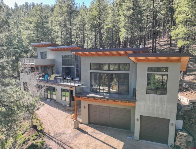 contemporary house featuring a balcony and a garage