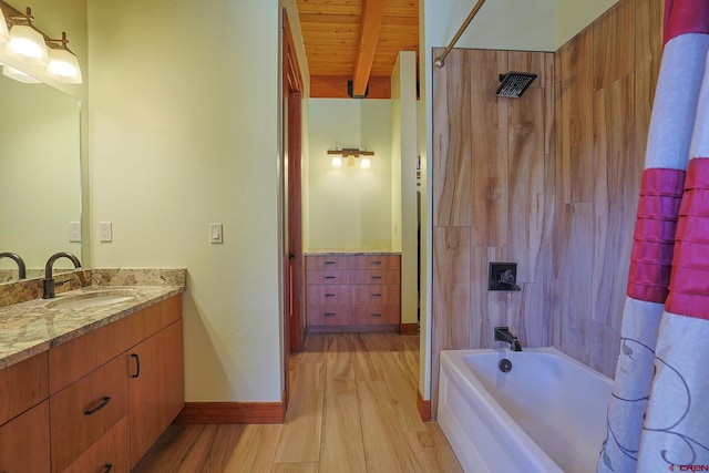 bathroom with hardwood / wood-style floors, wooden ceiling, shower / bath combo with shower curtain, beam ceiling, and vanity