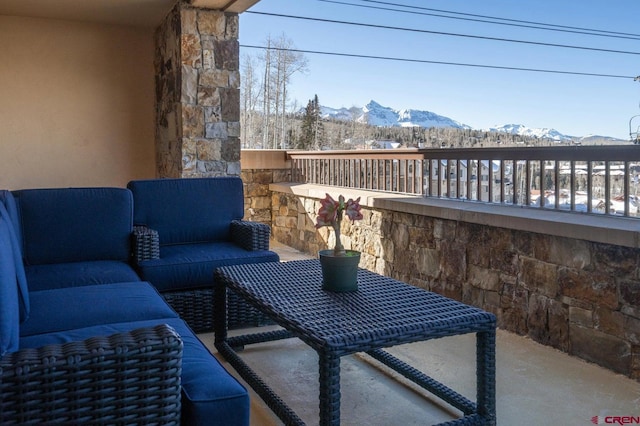 balcony featuring a mountain view and an outdoor hangout area