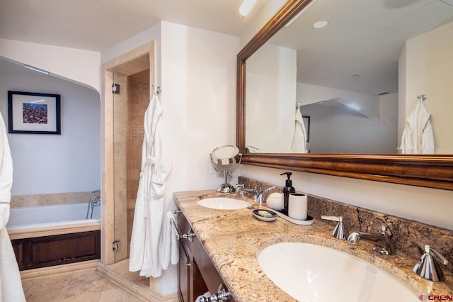 bathroom featuring tile patterned floors, vanity, and shower with separate bathtub