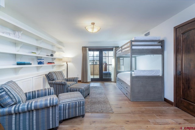 bedroom featuring light hardwood / wood-style flooring and french doors