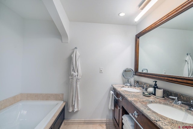 bathroom with vanity, a bath, and tile patterned flooring