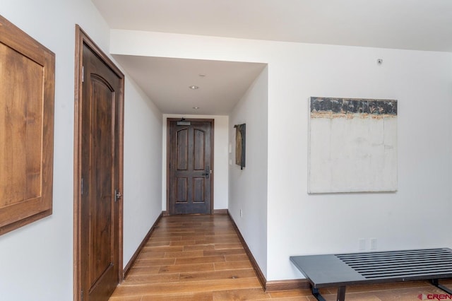 corridor with light hardwood / wood-style flooring