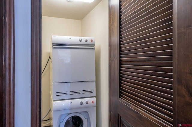 washroom featuring stacked washer and dryer