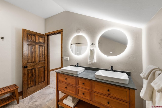 bathroom featuring vanity and vaulted ceiling