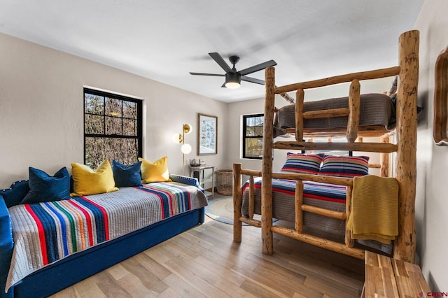 bedroom with ceiling fan and wood-type flooring