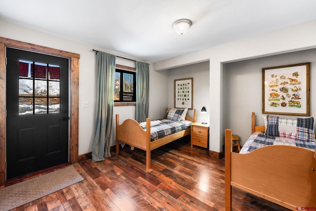 bedroom featuring dark hardwood / wood-style flooring and multiple windows