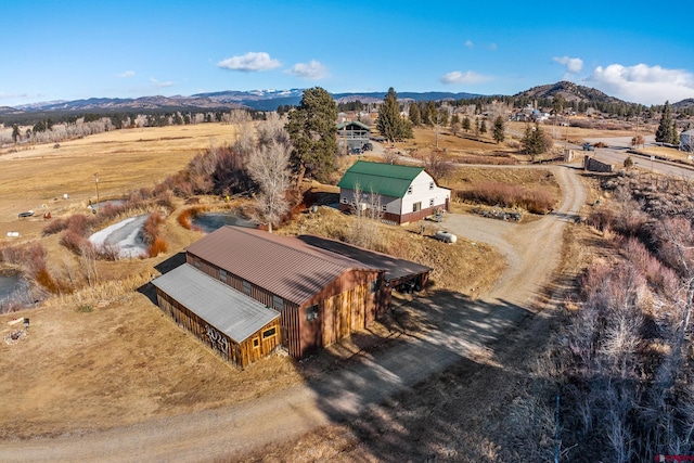 drone / aerial view featuring a mountain view and a rural view