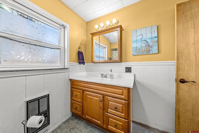 bathroom featuring heating unit and vanity