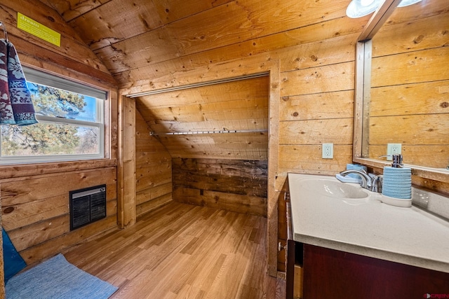 bathroom with hardwood / wood-style flooring, wooden ceiling, vanity, wooden walls, and lofted ceiling