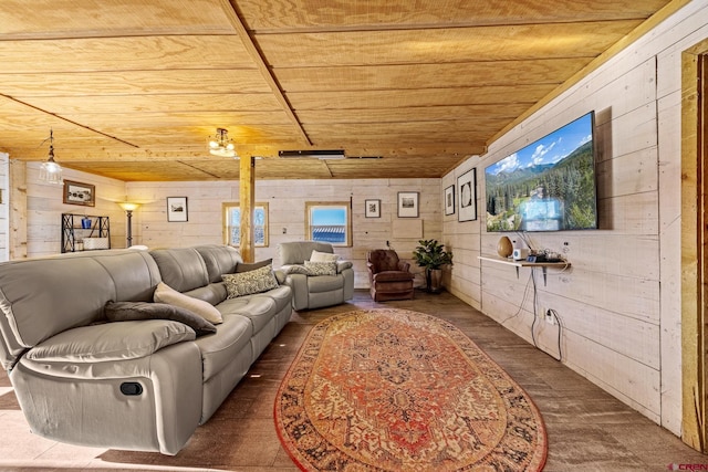 living room with dark wood-type flooring, wooden ceiling, and wood walls