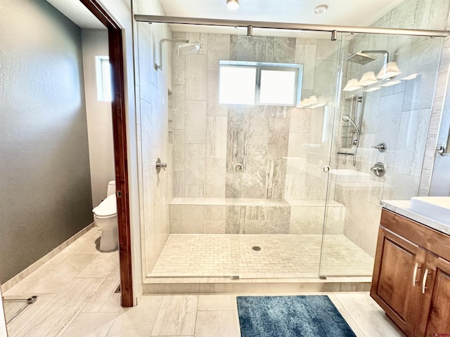 bathroom with tile patterned floors, toilet, walk in shower, and vanity