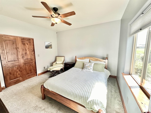 bedroom featuring ceiling fan, carpet flooring, and multiple windows