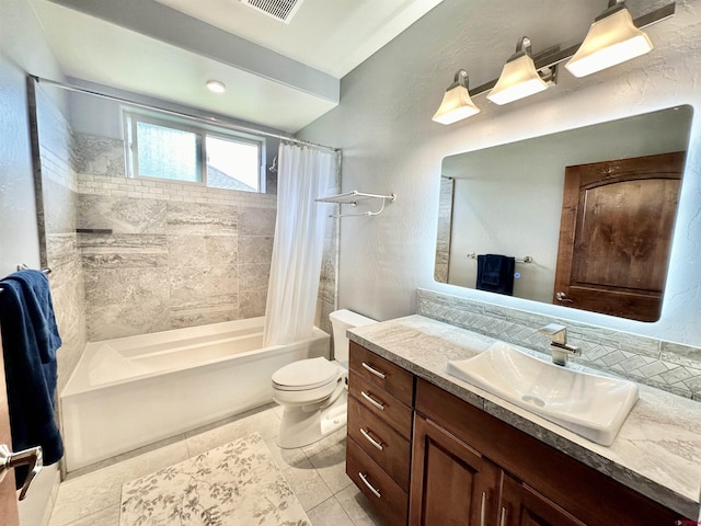 full bathroom with toilet, shower / tub combo with curtain, tile patterned floors, and vanity