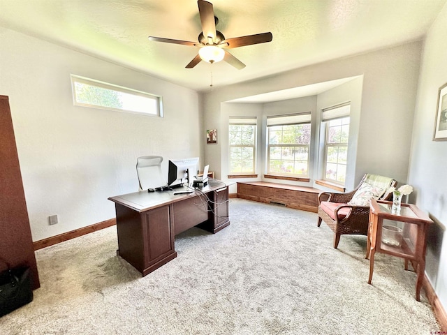 office space featuring ceiling fan and light carpet