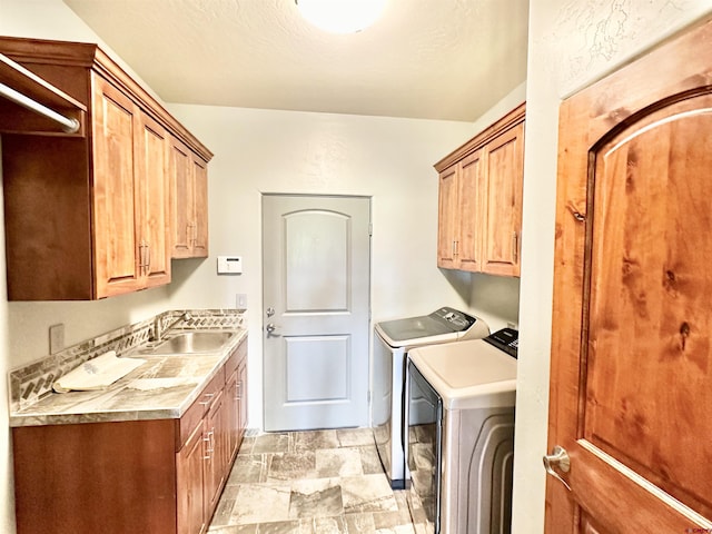 laundry area featuring cabinets, sink, and independent washer and dryer