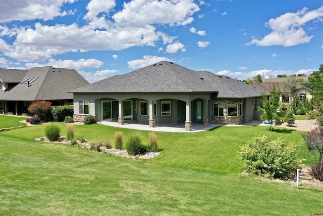 rear view of house featuring a patio area and a lawn