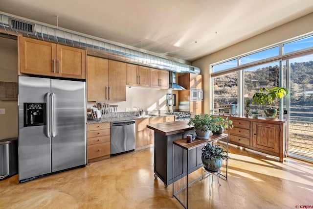 kitchen featuring stainless steel appliances, sink, a mountain view, and butcher block countertops