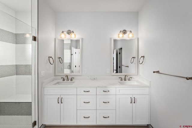 bathroom with walk in shower and vanity