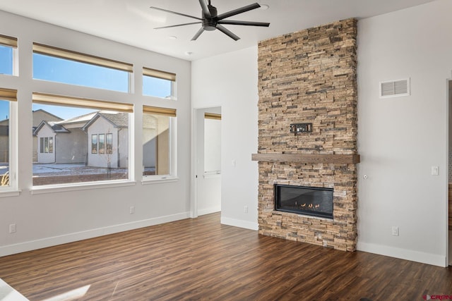 unfurnished living room featuring ceiling fan, dark hardwood / wood-style flooring, and a fireplace