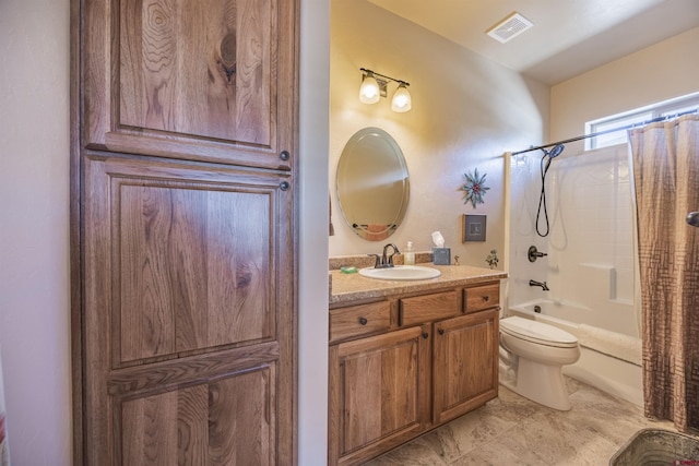 full bathroom with vanity, shower / tub combo, and toilet